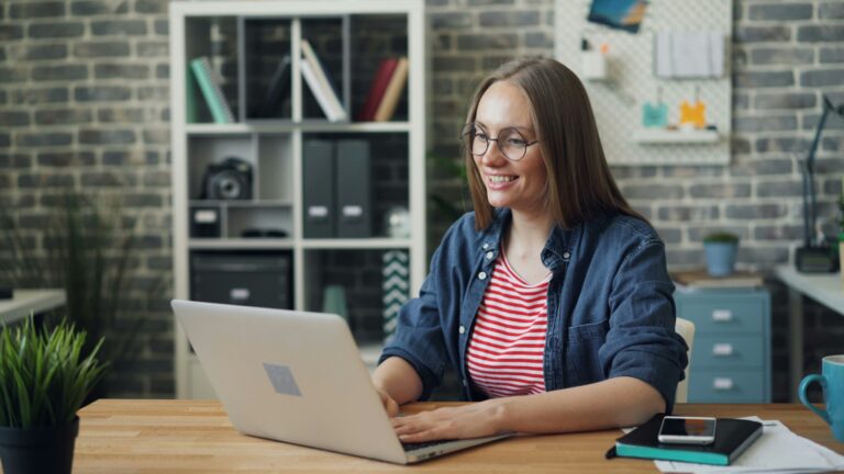 Happy woman looking at computer
